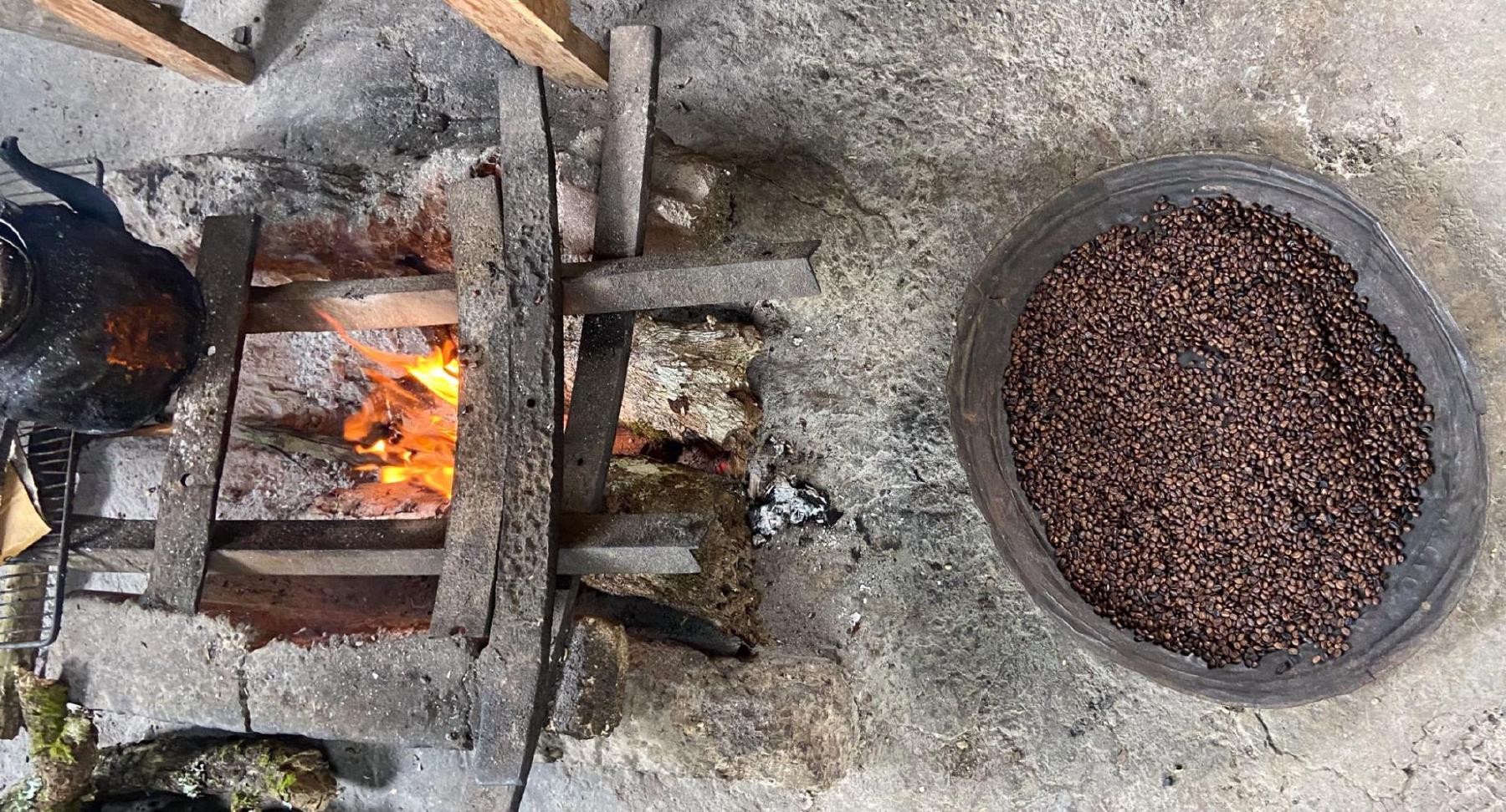 a fire of coffee wood and a pan of freshly roasted coffee