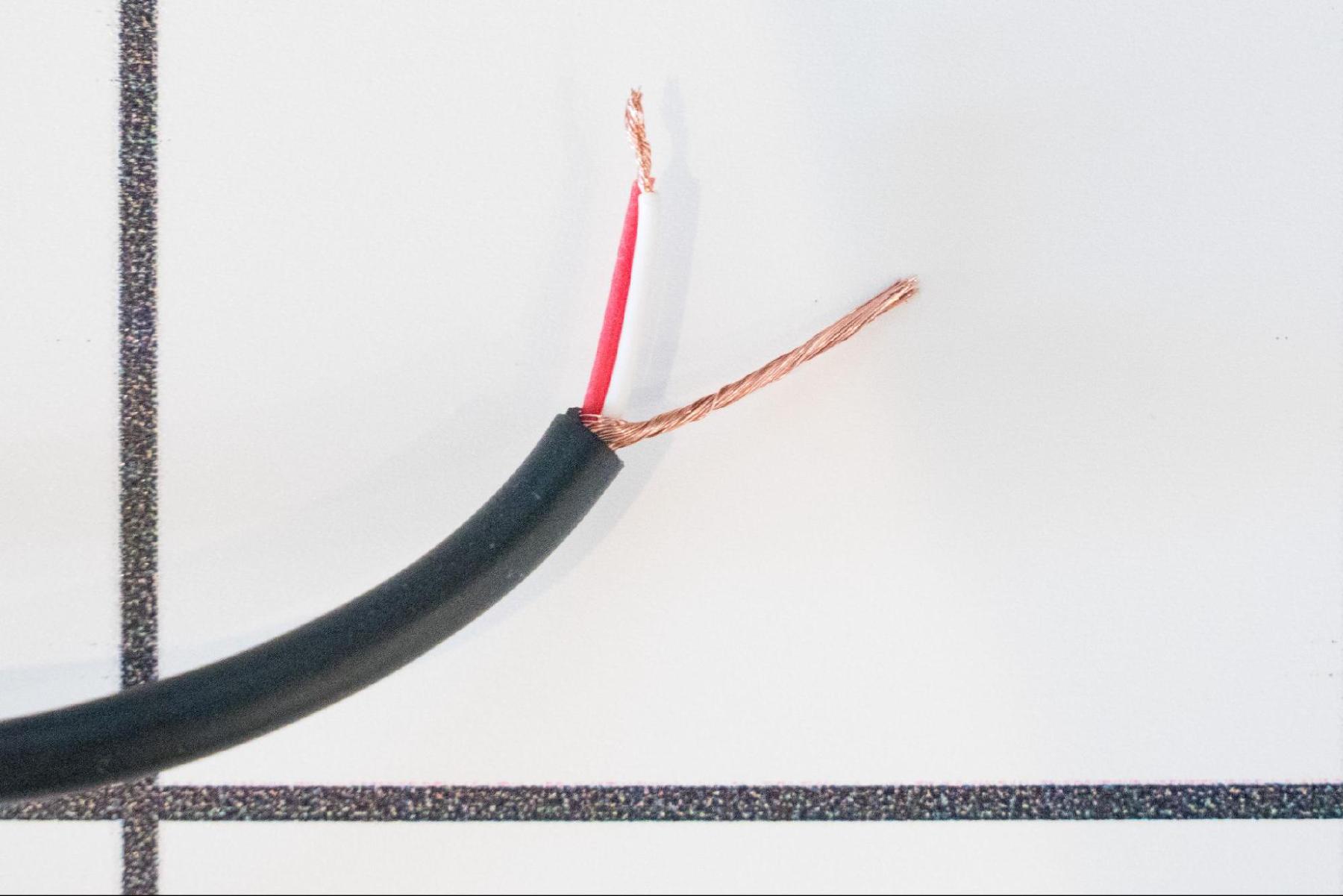 Stripped audio cable showing wires